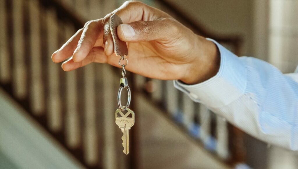 A hand holding house keys