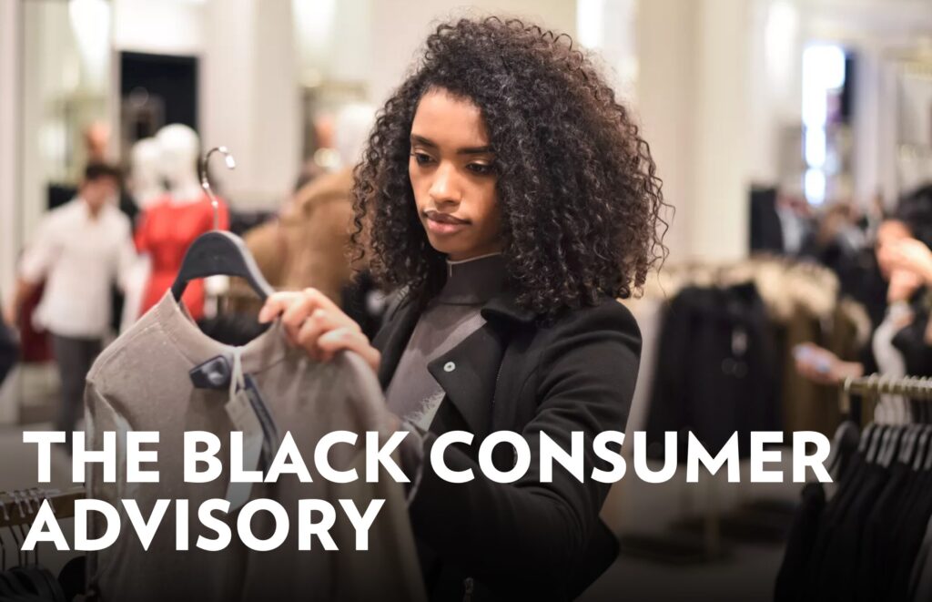 Photo: A young Black woman peruses clothing in a store, under a title reading "The Black Consumer Advisory"